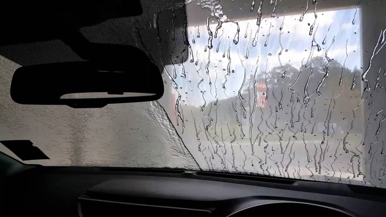 Glass coating before and after — water beading on windshield — Elite Premium Detailing Hollywood FL