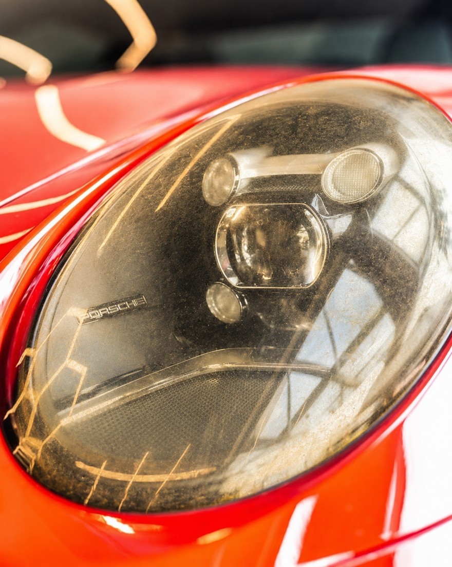 Foggy, oxidized Porsche headlight before restoration