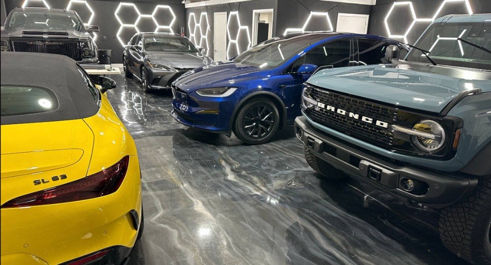 Inside the Elite Premium Detailing bay in Davie, FL — climate-controlled, cars under paint protection film