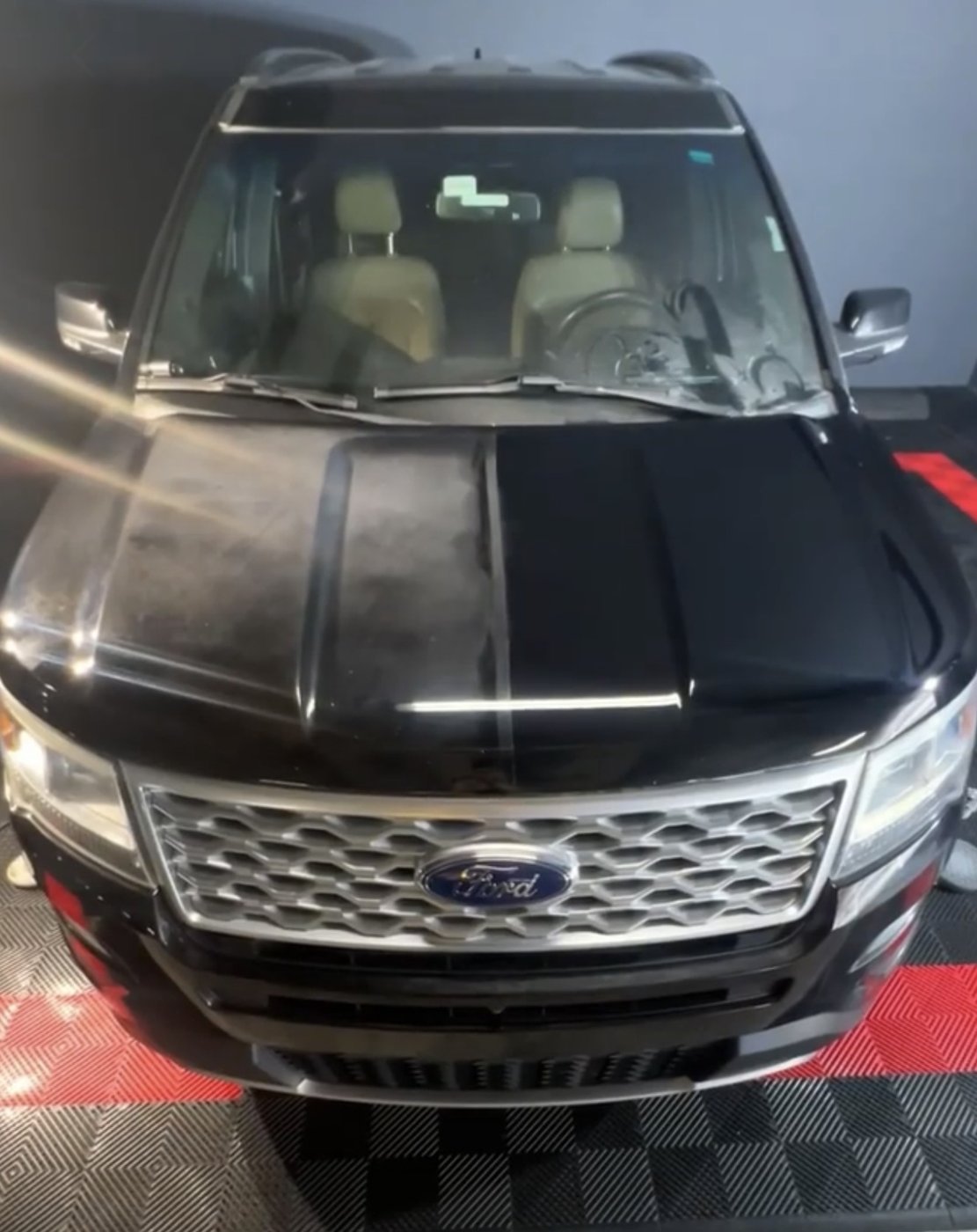 Paint correction on black SUV hood &mdash; corrected to a flawless finish