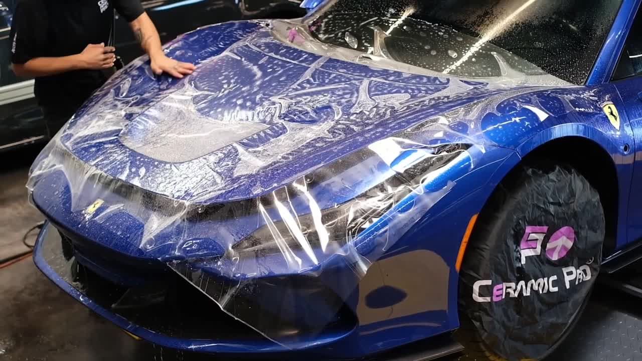 Paint protection film being installed over the front end of a Ferrari at Elite Premium Detailing
