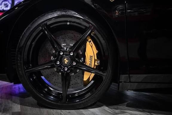 Ferrari yellow caliper behind black wheel