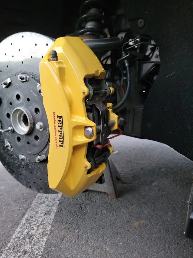 Ferrari brake caliper being painted at Elite Premium Detailing