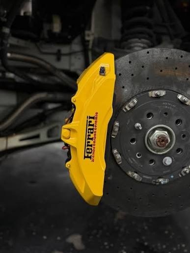 Ferrari caliper painted yellow on carbon ceramic rotor