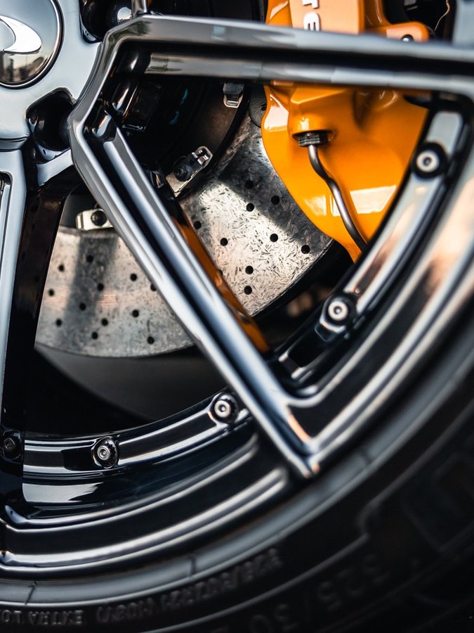 McLaren orange caliper through coated spokes