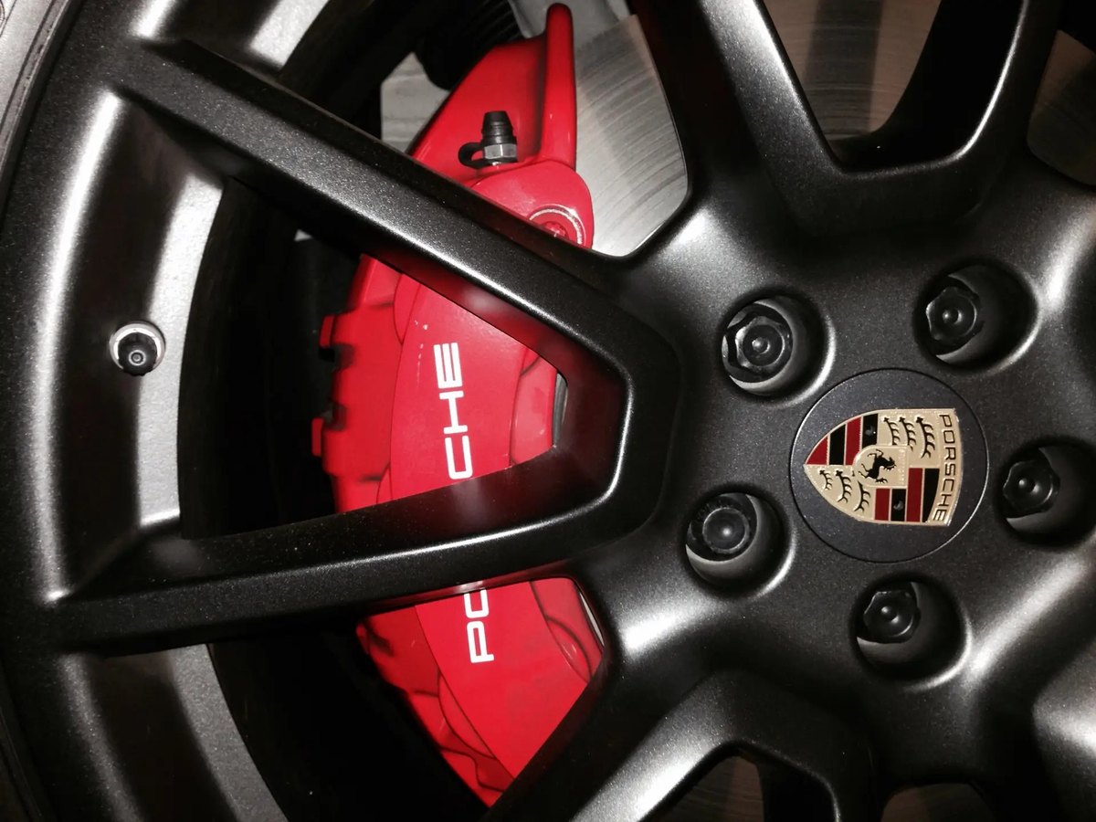 Matte black powder coated wheel with red Porsche caliper